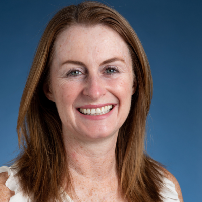 A headshot of Máire Ford on a blue background